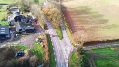 Aerial-view-of-an-old-farm-next-to-a-main-road