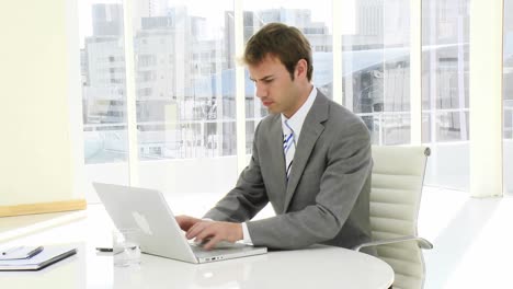 serious businessman working at a laptop
