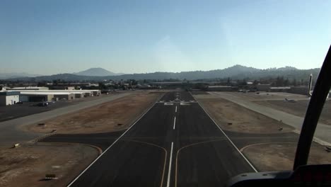 a plane heads down a runway and takes off