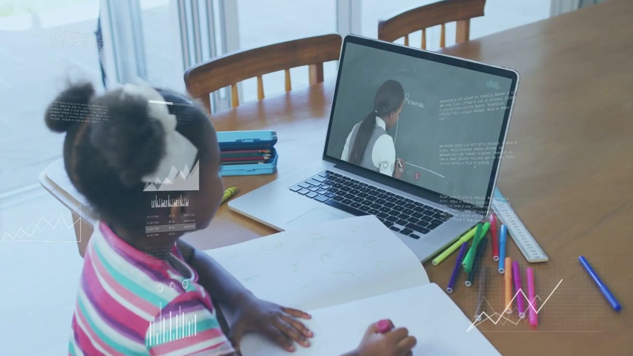 Child watching laptop teacher writing, reaching pink crayon, marking notebook following class