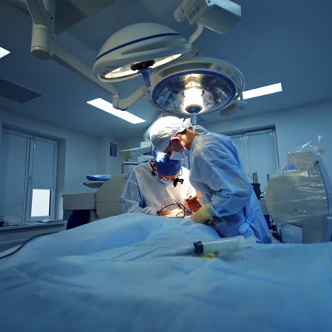 professional doctors with neurosurgical instruments. surgeons in sterile gloves work with modern medical tools. surgeons providing operation