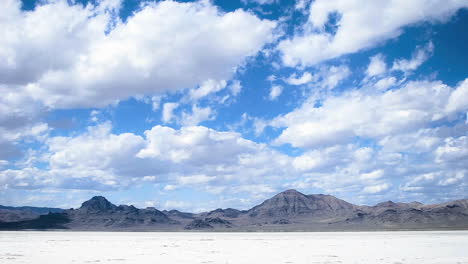 time lapse of clouds moving over salt flats or desert