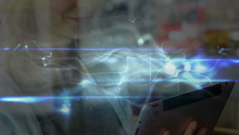 woman holding tablet in workspace, showcasing swirling blue data light effects for technology