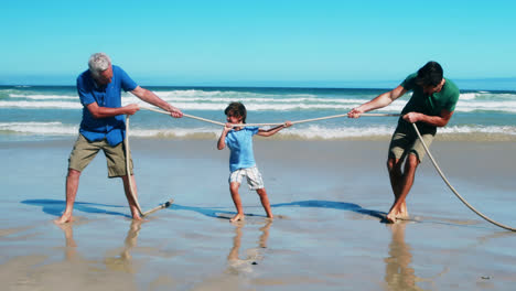 Familie-Spielt-Tauziehen-Am-Strand