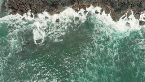 Vista-Aérea-De-Drones-De-Olas-Rompiendo-Contra-Las-Rocas-En-Una-Playa