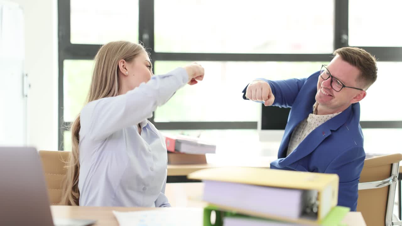 Business Colleagues Fist Bumping in an Office