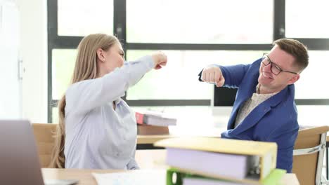 business colleagues fist bumping in an office