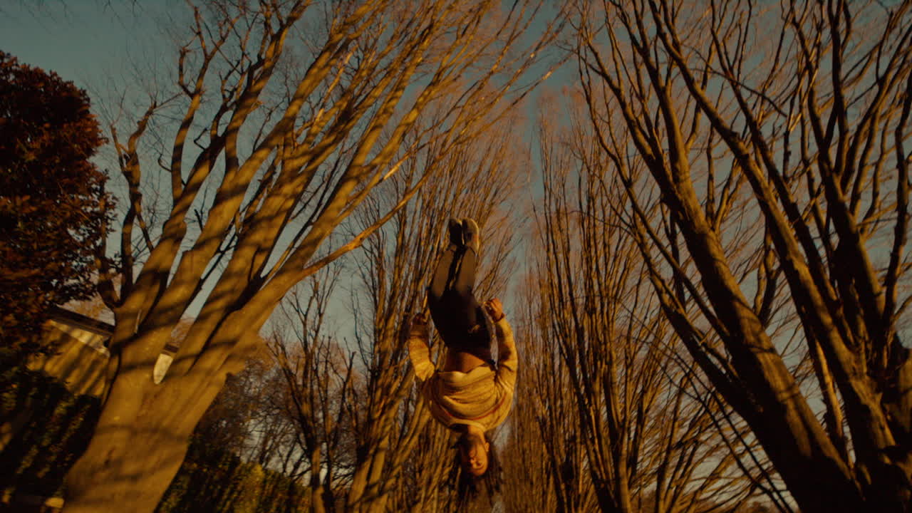 Person performing a flip in a park