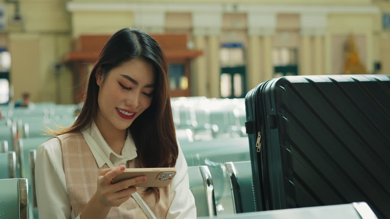 Woman using phone at the train station