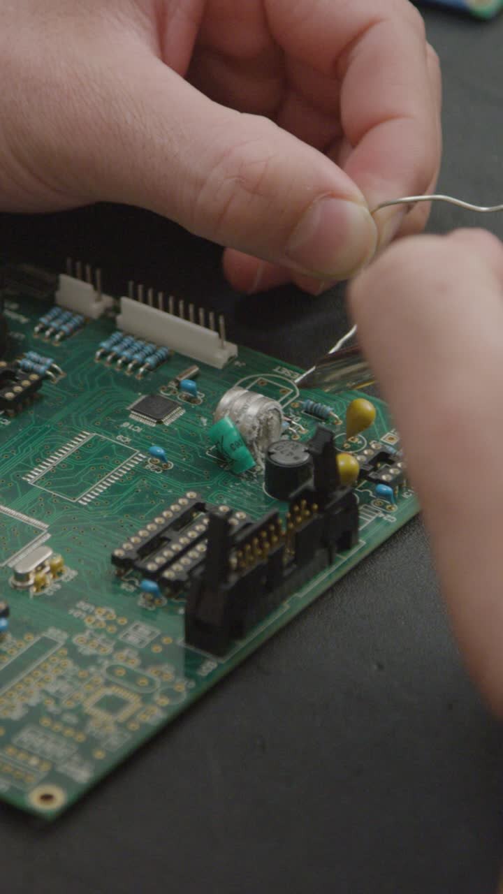 Vertical Shot of Student Soldering Circuit Board