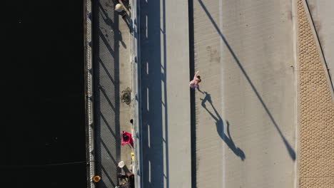 Person-ride-and-doing-tricks-with-skateboard-in-Seal-Beach-area,-drone-top-down-view