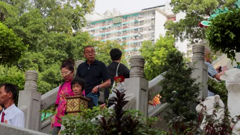 family walking down temple stairs in hong kong