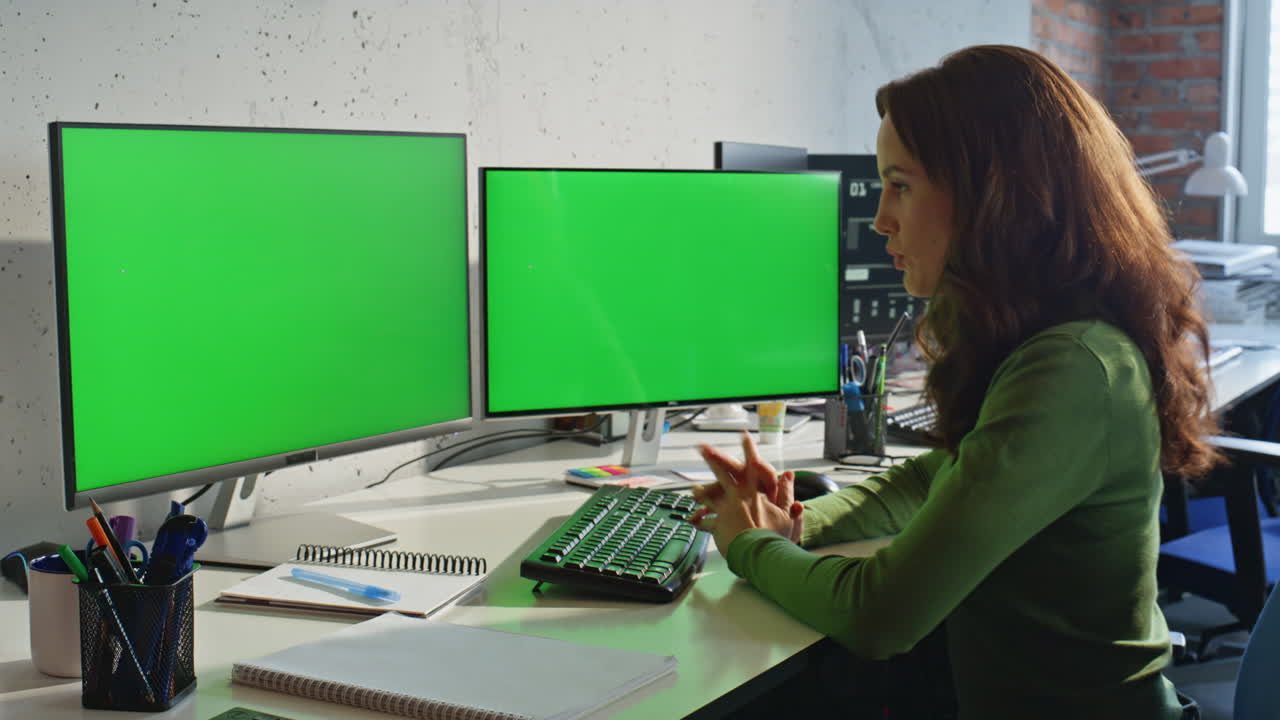 Lady tutor greenscreen videocall pc in modern office closeup. Woman talking