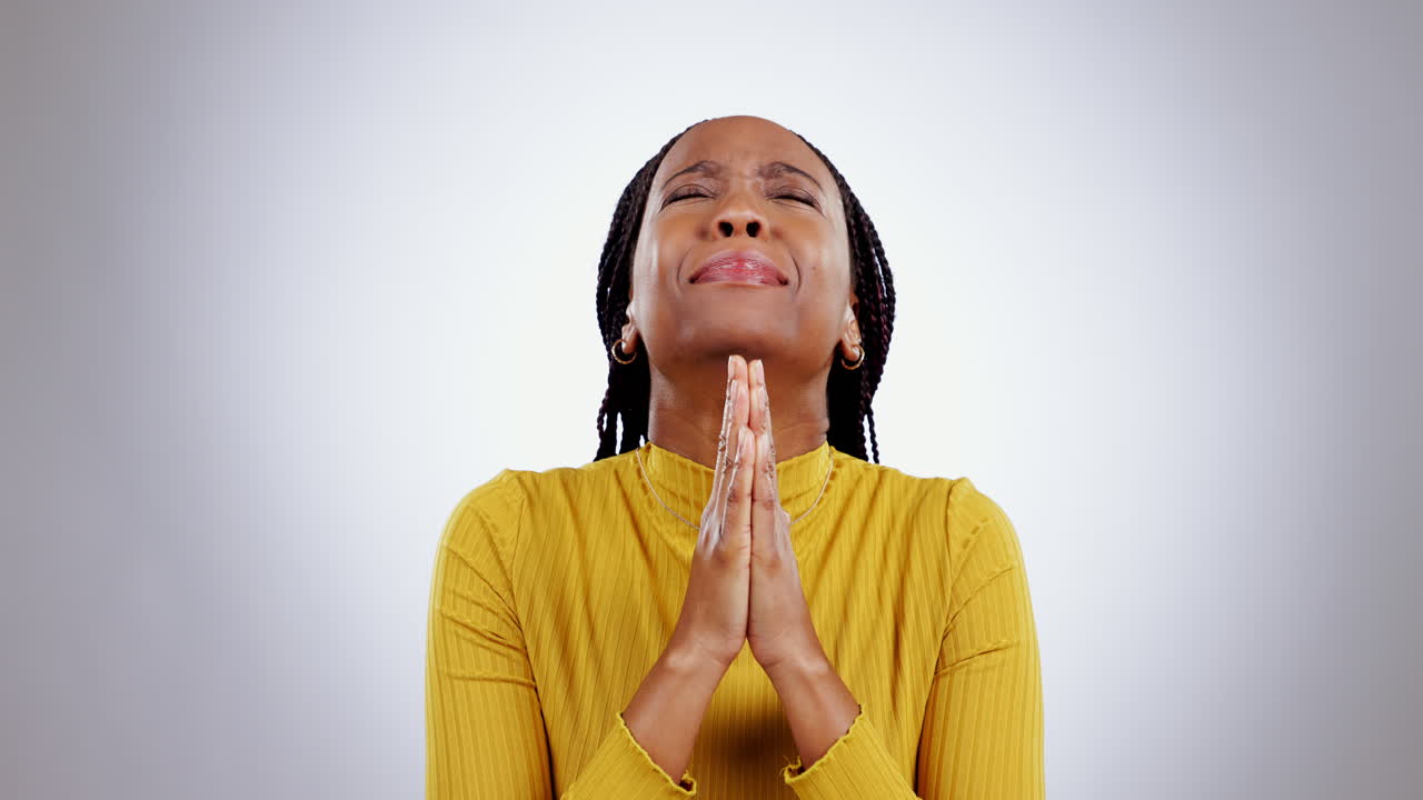 Praying, hands and black woman in studio
