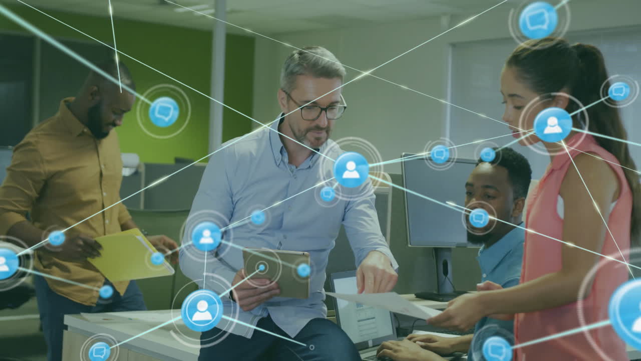 Animation of network of connections with icons over diverse colleagues using tablet in office