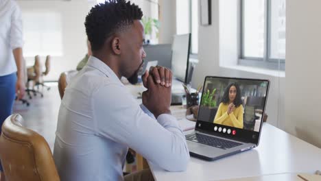 Animation-of-african-american-man-having-video-call-on-laptop