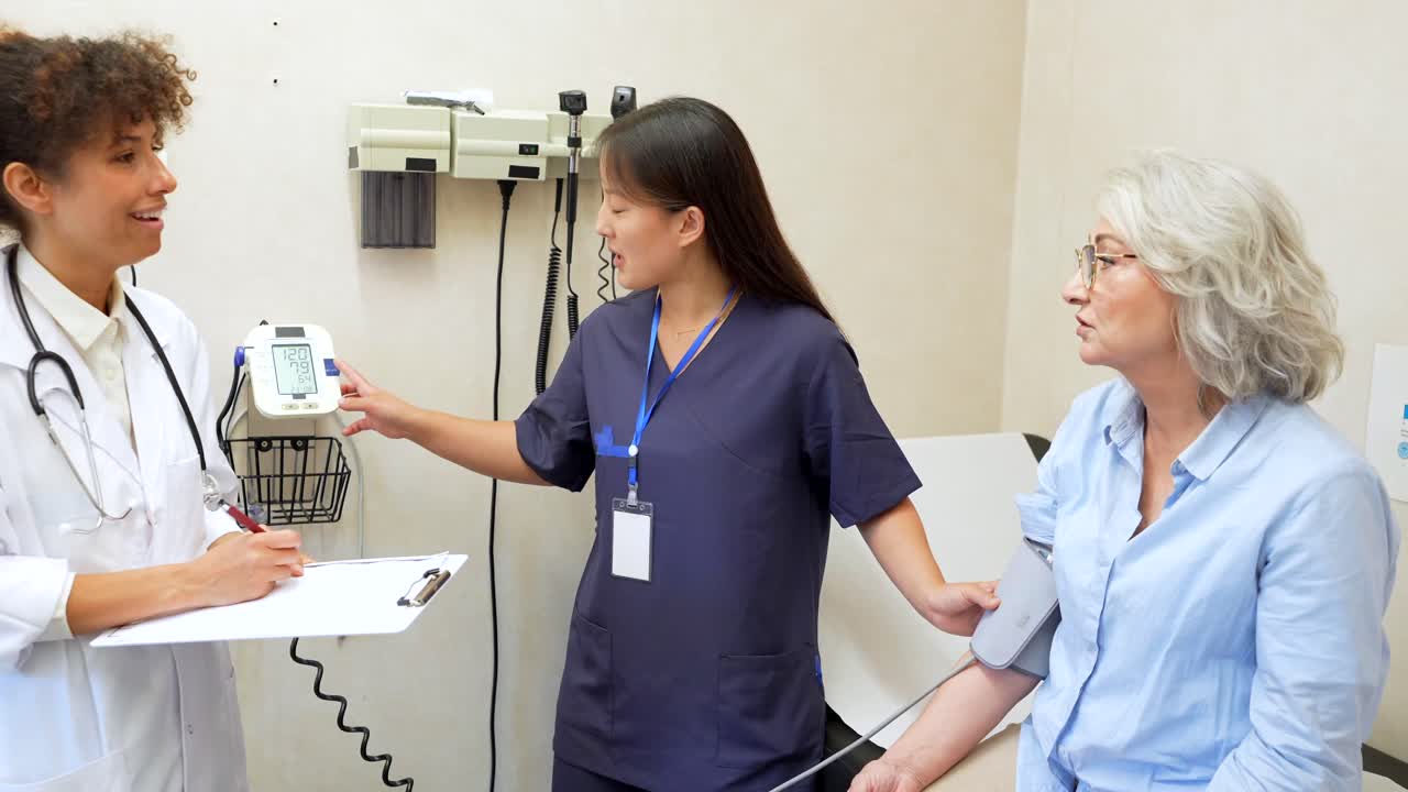 Doctor and Nurse Checking Patient's Blood Pressure
