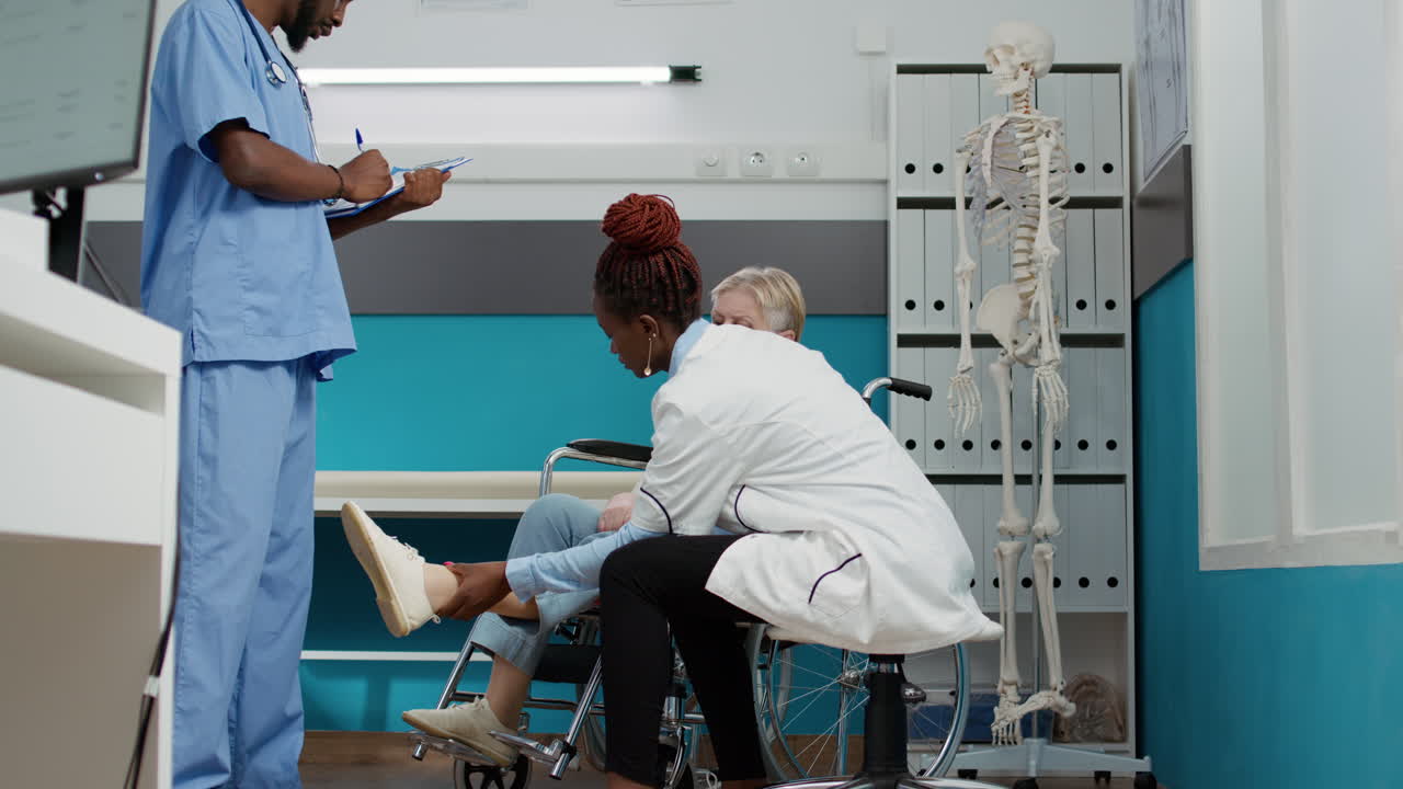 Medical Consultation with Doctor and Nurse Assisting Patient in Wheelchair