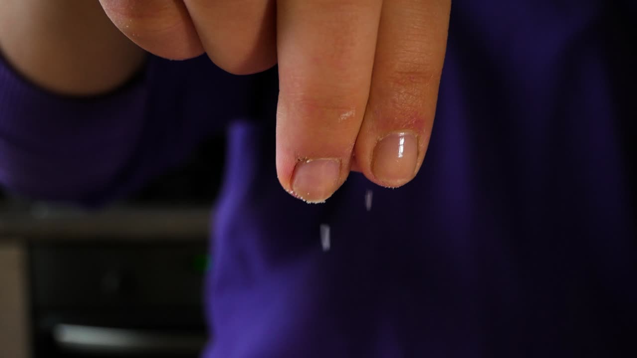 Homemade chef adds salt to the dish, cooking in slow motion.