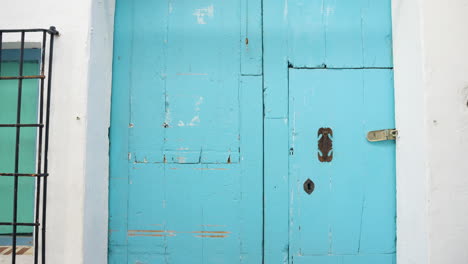 vintage light blue wooden door with metal hardware