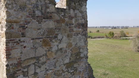 aerial descent down ancient stone wall of soltszentimre truncated tower, hungary