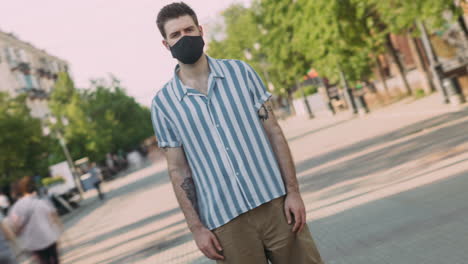 man wearing a mask in a city street