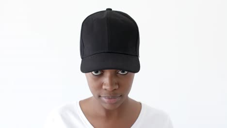 African-american-woman-wearing-black-peaked-cap-with-copy-space-on-white-background