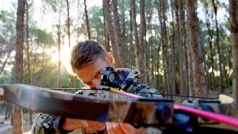 Man-aiming-with-compound-bow-in-the-forest-4k