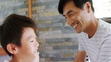 father and son giving high five to each other in bathroom 4k