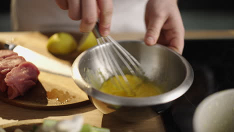 preparing food with eggs and meat