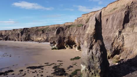 Sea-Stack-at-Ryhope-Cliffs-Hendon-Beach-in-Sunderland-North-East-UK,-Aerial-Drone-4K-HD-Fly-By-Right