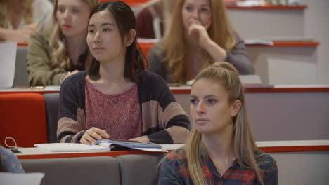 tilt shot of students in a university lecture theatre