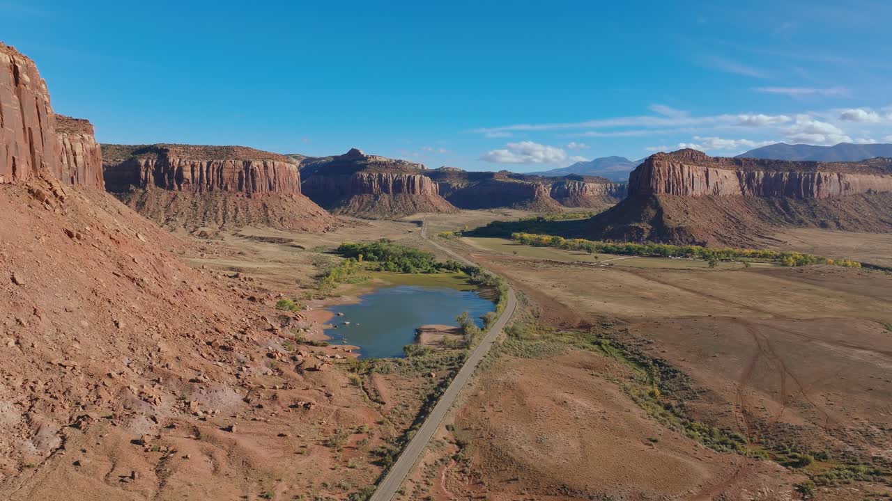 Vast red rock desert landscape in Moab's Indian Creek, USA, under blue sky