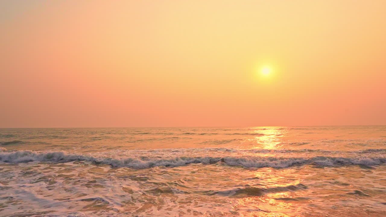 Pan across dramatic ocean sunset