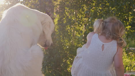 a child and a dog sharing a flower