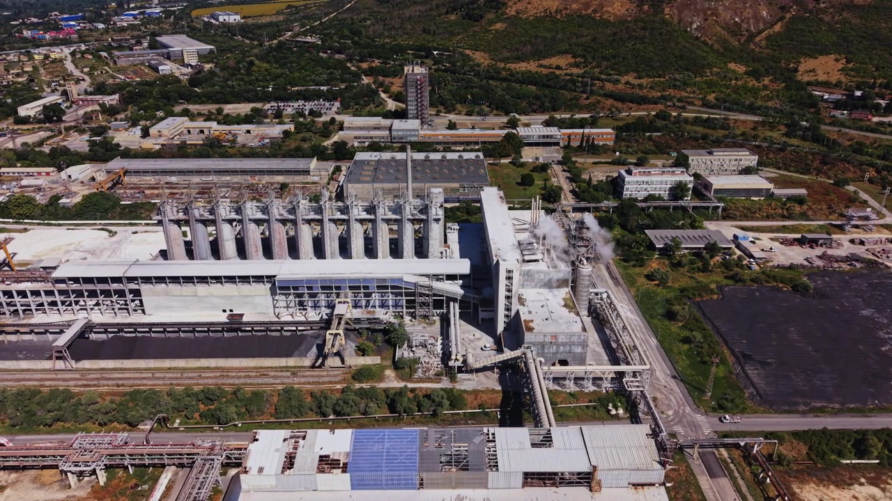 Industrial site near a mountain with various buildings and roads