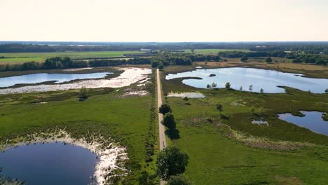 aerial view of dutch landscape with lakes and road