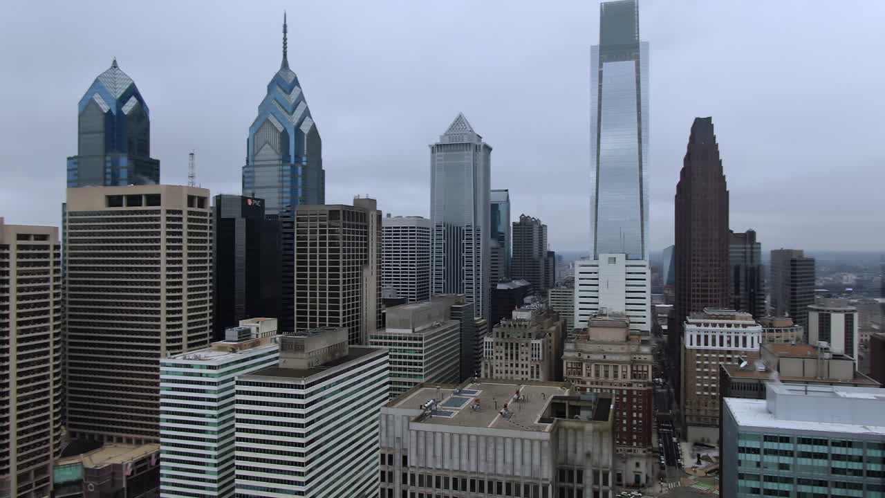Aerial view of Philadelphia with the City Hall's bell tower, William Penn statue in front and modern skyscrapers in the background, panoramic view of historic downtown area