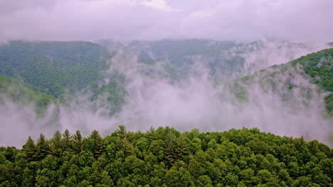 smoky mountains disappear into fog in this cinematic aerial shot
