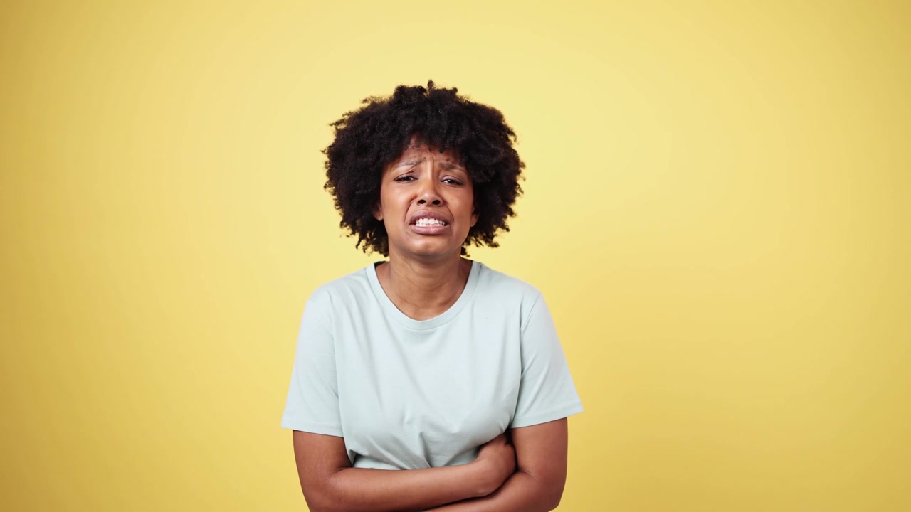 Young African American Woman Suffering from Stomach Pain