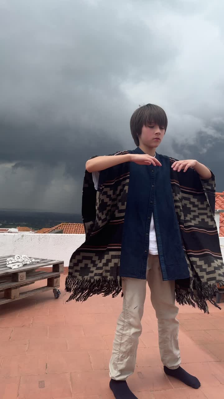Child on Rooftop in Poncho During Storm