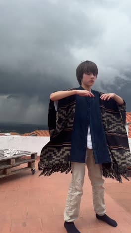 child on rooftop in poncho during storm
