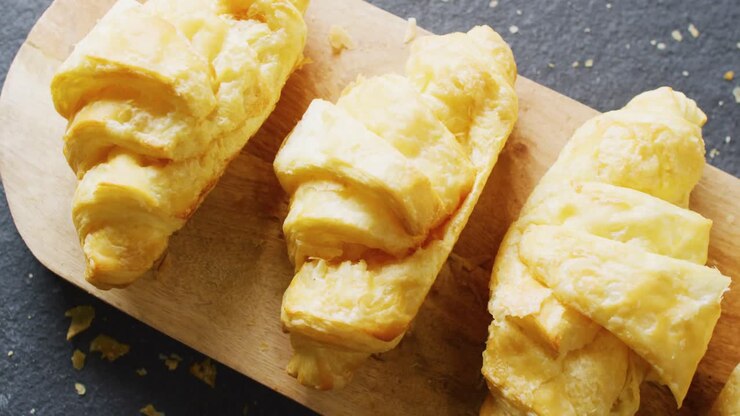 Video of close up of croissants on gray background