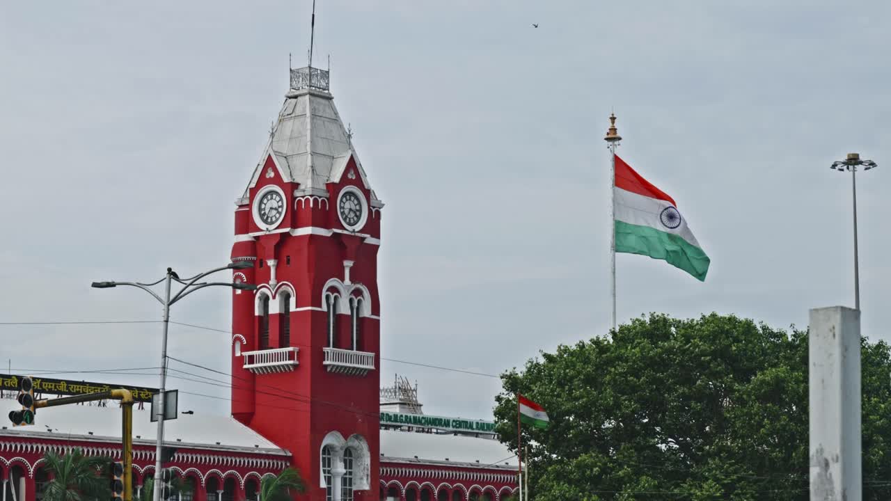 Chennai Central with clock, tree and two indian flags at periamet, kannappar thidal, chennai, tamil nadu, india. day time, stable shot, 4k.
