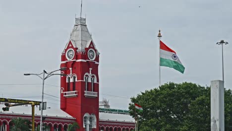 chennai central with clock, tree and two indian flags at periamet, kannappar thidal, chennai, tamil nadu, india. day time, stable shot, 4k.
