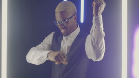 stylish man dancing under neon lights