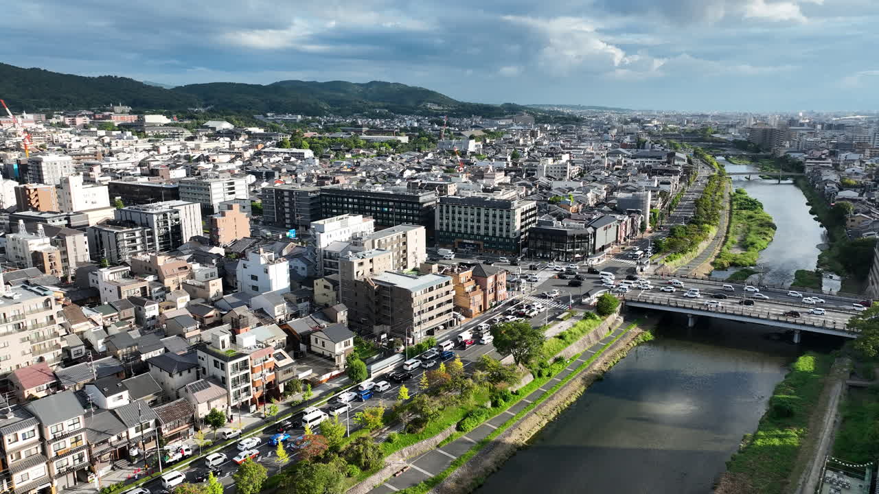 Scenic Aerial View Of Kyoto, Japan In Daytime With View Of Kamo River And Bustling Gojo Bridge