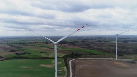 Farmwindmühlen-Wurden-An-Einem-Bewölkten-Tag-In-Kwidzyn,-Polen,-Auf-Grünen-Feldern-Abgeschaltet---Drohnenaufnahme