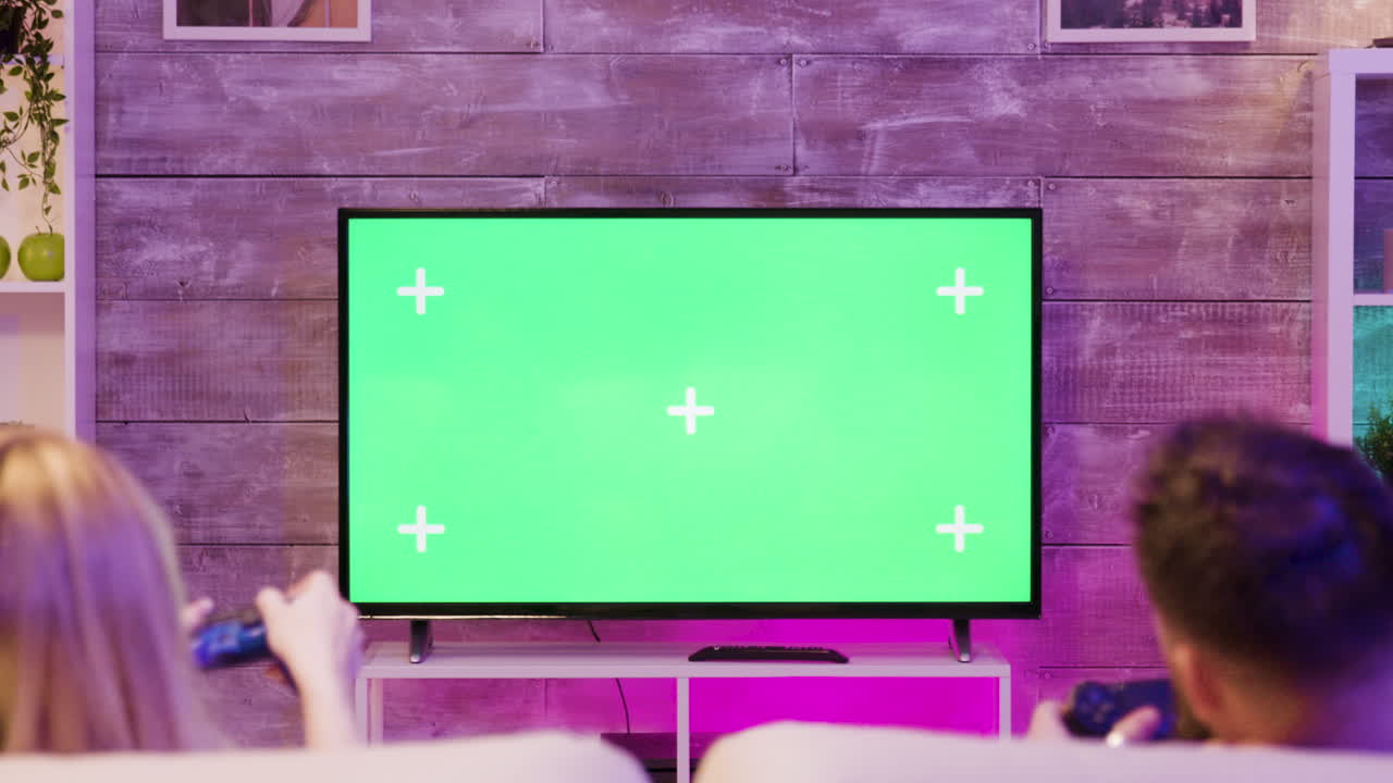 Couple Playing Video Games on Green Screen TV