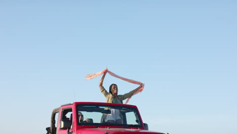 young african american woman enjoys a carefree moment outdoors on a road trip, with copy space